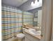 Bathroom featuring a striped shower curtain, white vanity, and neutral-toned walls at 6028 Hillside Heights Dr, Lakeland, FL 33812