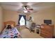 Bedroom featuring a bed, dresser, desk, chair, and window with curtains at 6028 Hillside Heights Dr, Lakeland, FL 33812