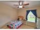 Bedroom with bed, dresser, and a window providing natural light at 6028 Hillside Heights Dr, Lakeland, FL 33812