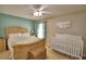 A sun-filled bedroom featuring a king bed and a bright white baby crib at 6028 Hillside Heights Dr, Lakeland, FL 33812