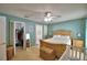 This bedroom features a walk-in closet, a ceiling fan, and warm, cozy decor at 6028 Hillside Heights Dr, Lakeland, FL 33812