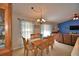 Dining room with table, six chairs, and view of living room with blue wall at 6028 Hillside Heights Dr, Lakeland, FL 33812