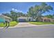 Charming single-Gathering home with a well-manicured lawn, a two-car garage, and a neutral color palette at 6028 Hillside Heights Dr, Lakeland, FL 33812