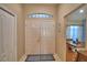 Bright foyer features a high ceiling, double front doors, and view into adjacent rooms at 6028 Hillside Heights Dr, Lakeland, FL 33812