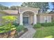 Inviting home entrance with a covered porch, decorative columns, and manicured landscaping at 6028 Hillside Heights Dr, Lakeland, FL 33812