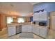 Open kitchen featuring white cabinets, stainless dishwasher and a connecting dining area at 6028 Hillside Heights Dr, Lakeland, FL 33812