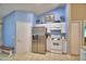 Well-lit kitchen with stainless steel refrigerator, white appliances, and ample cabinet space at 6028 Hillside Heights Dr, Lakeland, FL 33812