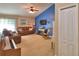 Comfortable living room features a ceiling fan and large television at 6028 Hillside Heights Dr, Lakeland, FL 33812