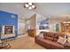 Open-concept living space with leather sofa, piano, and view into the kitchen at 6028 Hillside Heights Dr, Lakeland, FL 33812