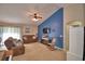 Cozy living room featuring a ceiling fan and a large television at 6028 Hillside Heights Dr, Lakeland, FL 33812
