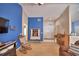 Inviting living room featuring a rocking chair, piano, and blue accent wall at 6028 Hillside Heights Dr, Lakeland, FL 33812