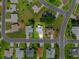A bird's eye view of the property nestled in a tranquil neighborhood, surrounded by lush greenery and mature trees at 6192 Magpie Dr, Lakeland, FL 33809