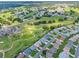Expansive aerial view of a vibrant residential community with lush green golf course at 6192 Magpie Dr, Lakeland, FL 33809