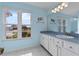 Bathroom featuring white tile floors, light blue walls, and a vanity with white cabinets at 6192 Magpie Dr, Lakeland, FL 33809