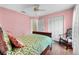 Bedroom with hardwood flooring, ceiling fan, and bright lighting at 6192 Magpie Dr, Lakeland, FL 33809