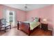 Bedroom with wood flooring, chair, and window view at 6192 Magpie Dr, Lakeland, FL 33809