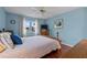 Cozy bedroom featuring hardwood floors, ceiling fan, and view from the window at 6192 Magpie Dr, Lakeland, FL 33809