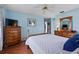 Comfortable bedroom with hardwood floors, a ceiling fan, blue walls, and traditional furniture at 6192 Magpie Dr, Lakeland, FL 33809