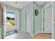 Inviting entryway with tiled floors, light green walls, and a view of the bright outdoors at 6192 Magpie Dr, Lakeland, FL 33809