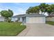 Charming single-story home with a well-manicured lawn and a two-car garage in a peaceful neighborhood at 6192 Magpie Dr, Lakeland, FL 33809
