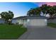 Charming single-story home with a well-manicured lawn, attached two-car garage, and inviting curb appeal at 6192 Magpie Dr, Lakeland, FL 33809