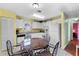 Sunny eat-in kitchen features white cabinetry, tile floors, and a cheerful yellow color scheme at 6192 Magpie Dr, Lakeland, FL 33809
