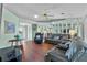 Comfortable living room featuring hardwood floors, mirrored walls, and soft, light green paint at 6192 Magpie Dr, Lakeland, FL 33809