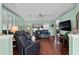 Bright living room with hardwood floors, a ceiling fan, comfortable seating, and a view to the outside at 6192 Magpie Dr, Lakeland, FL 33809