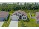 Single-Gathering home on a manicured lot near a pond with abundant trees and a two car garage at 6300 Dolostone Dr, Lakeland, FL 33811