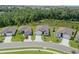 Aerial shot of neighborhood homes, emphasizing property's location with scenic pond and landscaping at 6300 Dolostone Dr, Lakeland, FL 33811