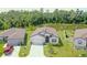 Aerial view of a single-Gathering home with pond and treeline in the backyard at 6300 Dolostone Dr, Lakeland, FL 33811