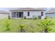 This backyard features immature landscaping and the perfect start to your tropical oasis at 6300 Dolostone Dr, Lakeland, FL 33811