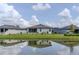 Residential backyard featuring a pond view, screened enclosure, and tranquil surroundings at 6300 Dolostone Dr, Lakeland, FL 33811