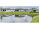 A backyard view shows a pond behind a home, enhancing the property's serene appeal at 6300 Dolostone Dr, Lakeland, FL 33811