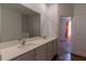 Bright bathroom featuring a double sink vanity with white cabinets and a large mirror at 6300 Dolostone Dr, Lakeland, FL 33811