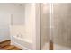 Bathroom with a soaking tub and separate glass-enclosed shower, designed for relaxation and convenience at 6300 Dolostone Dr, Lakeland, FL 33811