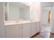 Bathroom featuring a double sink vanity, modern fixtures, and a large mirror, combining style and functionality at 6300 Dolostone Dr, Lakeland, FL 33811