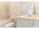 Bathroom featuring a shower-tub combo, toilet, and single sink vanity at 6300 Dolostone Dr, Lakeland, FL 33811