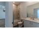 Bathroom featuring a shower-tub combo, toilet, and vanity with light countertops at 6300 Dolostone Dr, Lakeland, FL 33811
