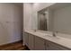 Bright bathroom featuring a double sink vanity with white cabinets, and a shower with glass doors at 6300 Dolostone Dr, Lakeland, FL 33811