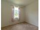 Bedroom featuring a window with curtains and carpeted floors at 6300 Dolostone Dr, Lakeland, FL 33811