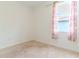 Bright bedroom with neutral carpet and a window with patterned curtains at 6300 Dolostone Dr, Lakeland, FL 33811