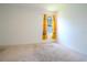 Cozy bedroom featuring carpet flooring and natural light streaming through the colorful floral curtains at 6300 Dolostone Dr, Lakeland, FL 33811