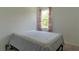 Cozy bedroom with a bed, floral curtains, and a window offering natural light at 6300 Dolostone Dr, Lakeland, FL 33811