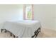 Bright bedroom featuring a large window, neutral carpet, and light walls at 6300 Dolostone Dr, Lakeland, FL 33811
