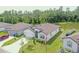 Beautiful single-Gathering home with a well-manicured lawn, an American flag, and a serene lake view at 6300 Dolostone Dr, Lakeland, FL 33811