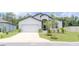 Charming front exterior with a two-car garage, manicured lawn, and lovely landscaping at 6300 Dolostone Dr, Lakeland, FL 33811