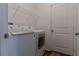 Laundry room with a washer, dryer, shelving, and white door at 6300 Dolostone Dr, Lakeland, FL 33811