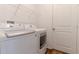 The laundry room features modern appliances, storage shelves, and a door to the side at 6300 Dolostone Dr, Lakeland, FL 33811