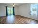 Spacious living room featuring hardwood floors and sliding door access to the outdoor patio at 6300 Dolostone Dr, Lakeland, FL 33811